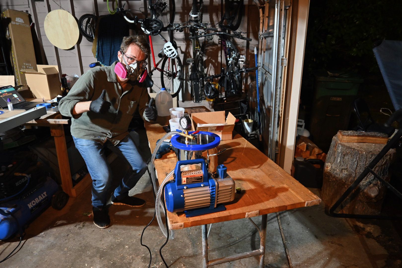 In the workshop with the vacuum chamber, pump, and investment-mold setup.